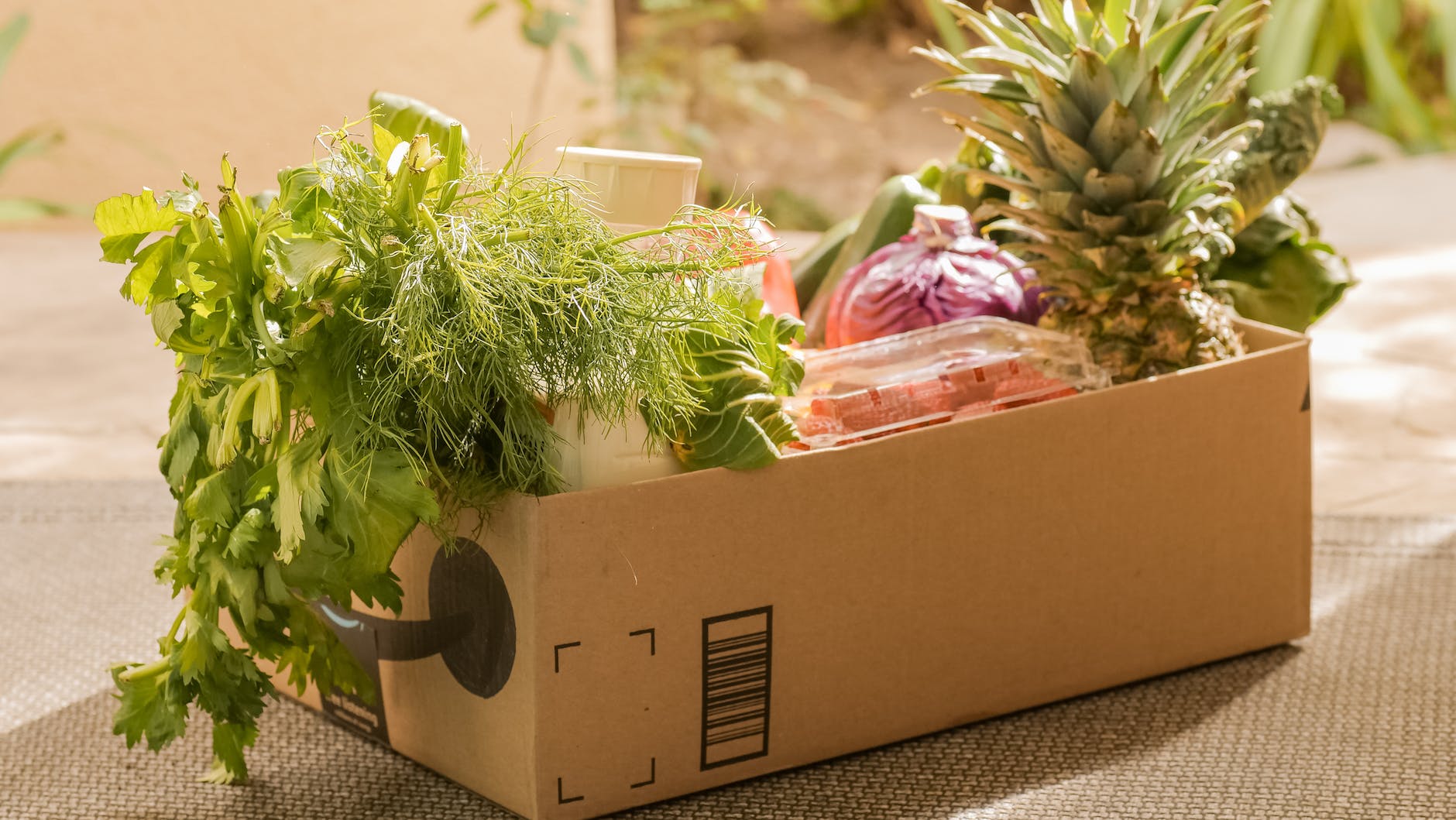 brown box with green leafy vegetables